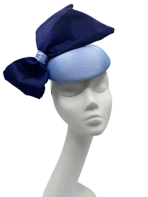 Stunning steel baby blue raw silk base headpiece with a beautiful raw silk navy side bow to finish.
